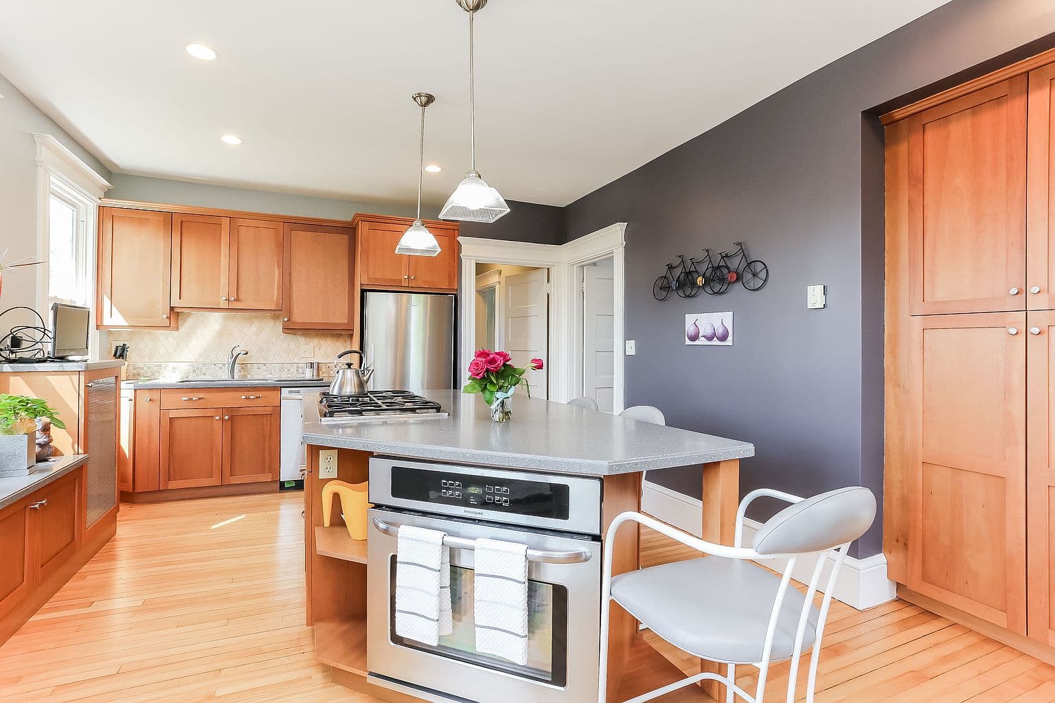 Kitchen with white cabinets and a window in the second-floor apartment on Grennan Rd.