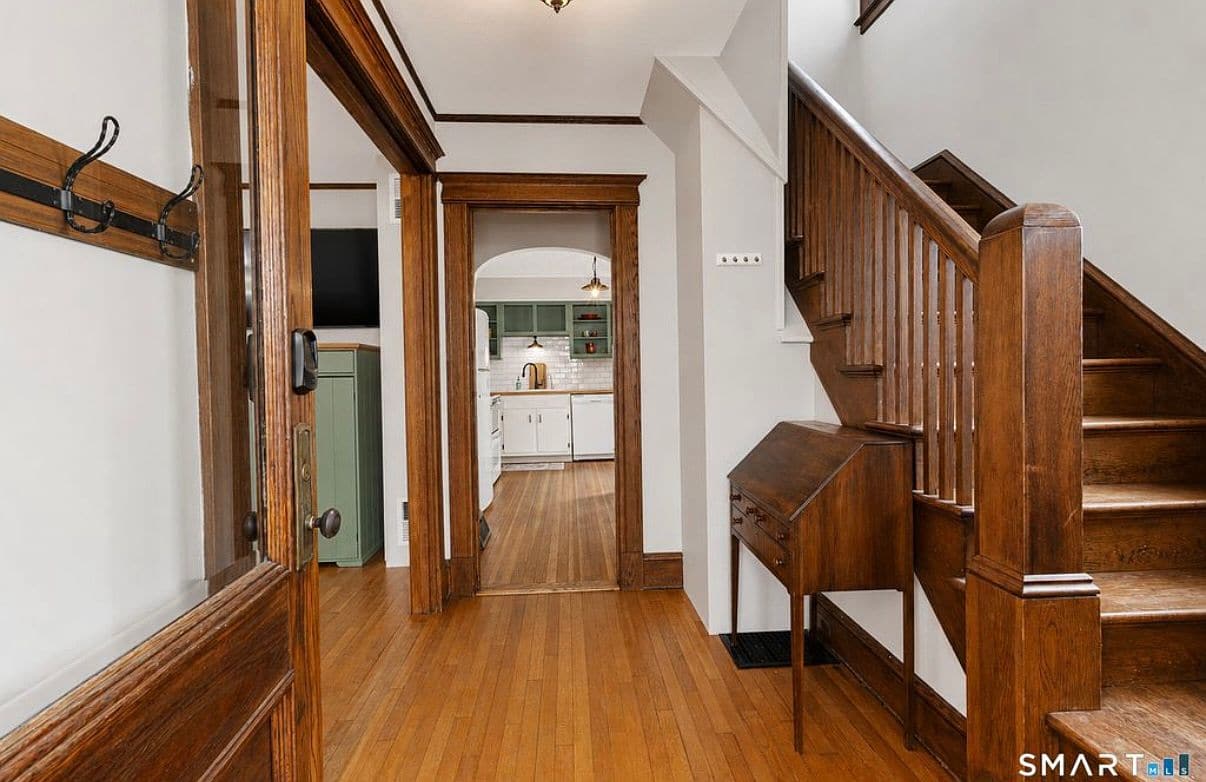 Living room with a fireplace and hardwood floors in the house on Jessamine St.